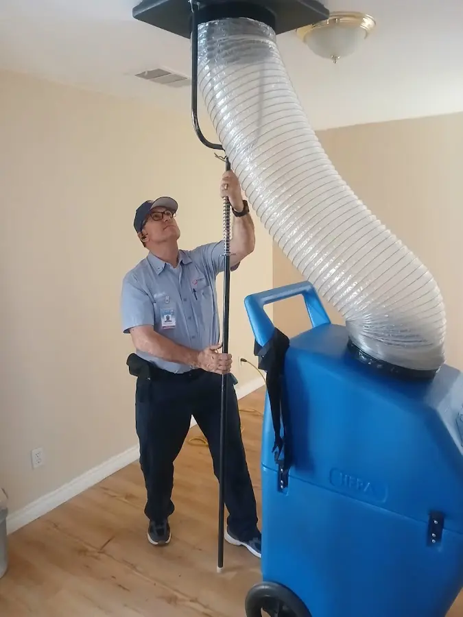 Furnace Tune-Up technician using HEPA equipment in Woodfin